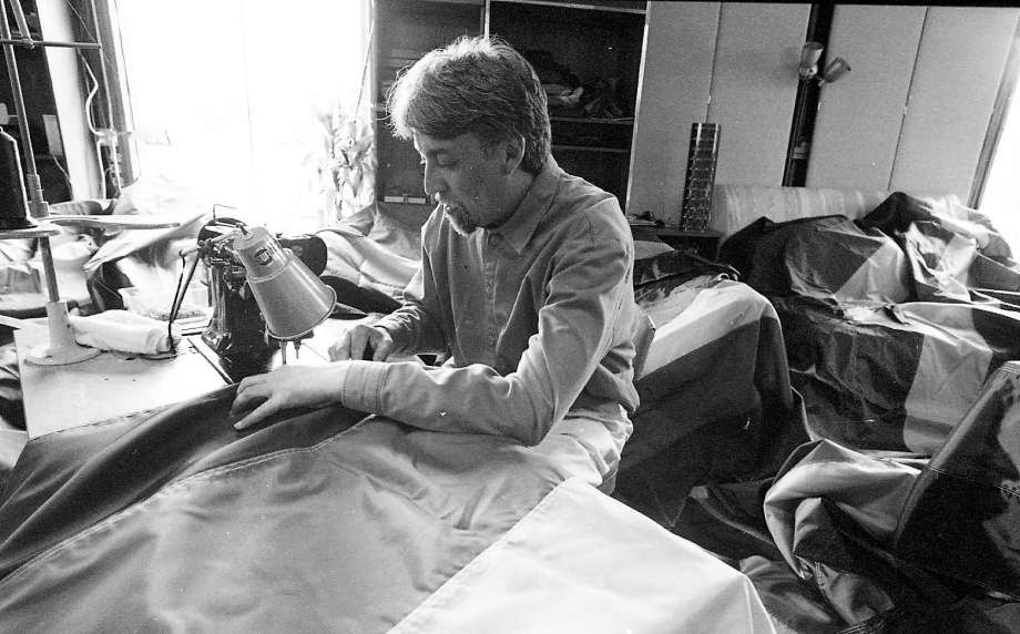 An image of Gilbert Baker sewing pride flags in 1998.