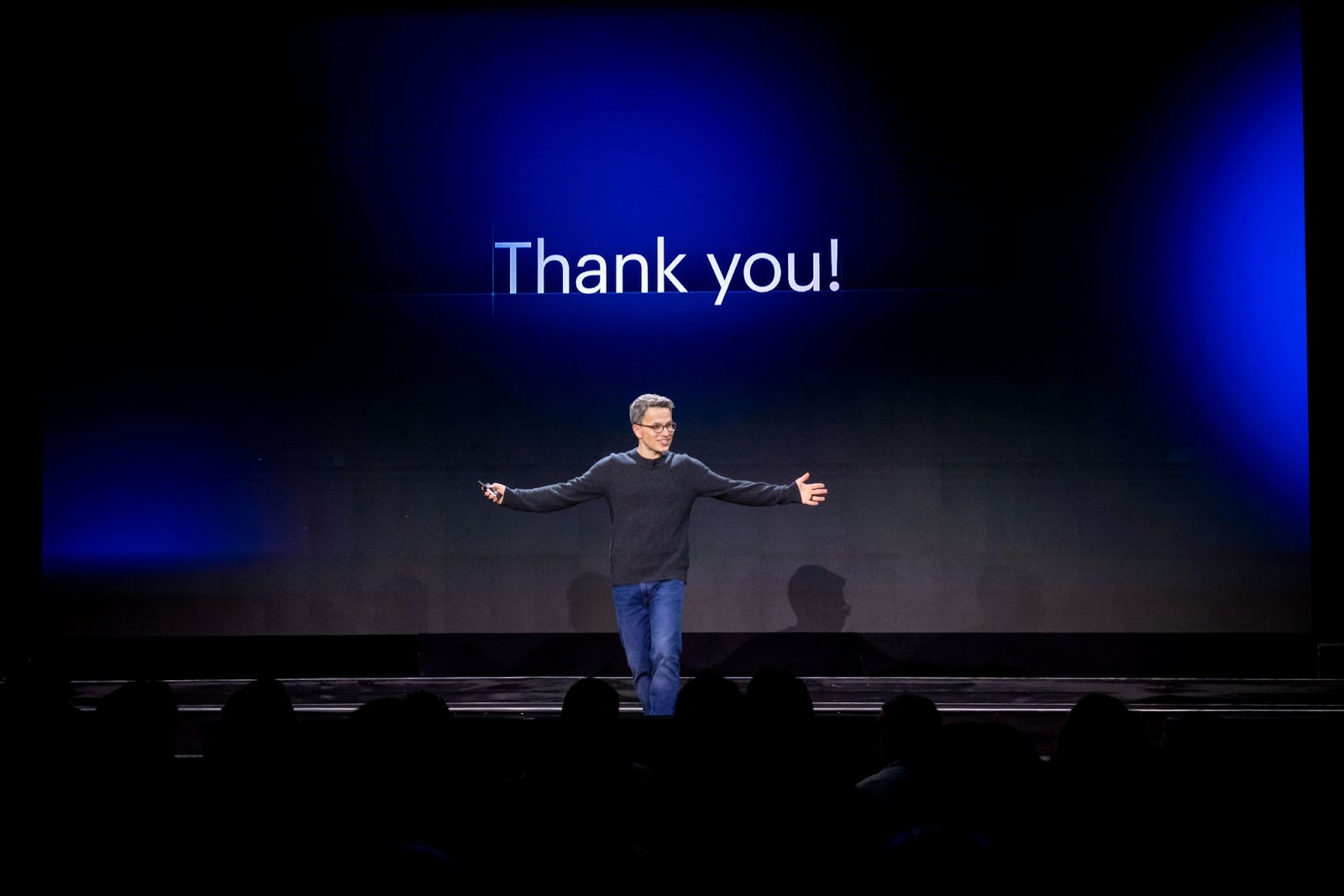 Vlad Magdalin on stage, smiling in front of a big screen with text "Thank you!"