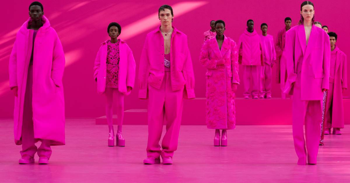 A photo of a dozen models wearing monochrome hot pink outfits from Valentino’s fall-winter collection.