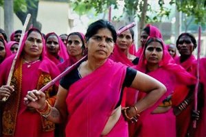 An image of the Gulabi Gang standing and posing in magenta sarees