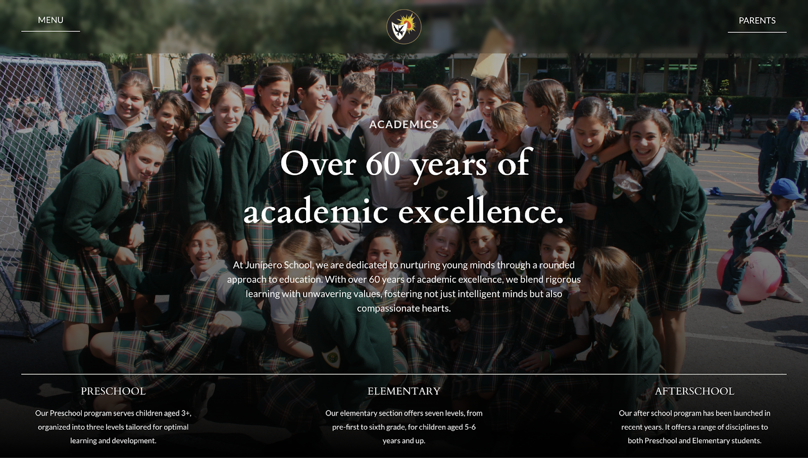A screenshot of Colegio Junípero’s website showing a header image of students with white text overlay.