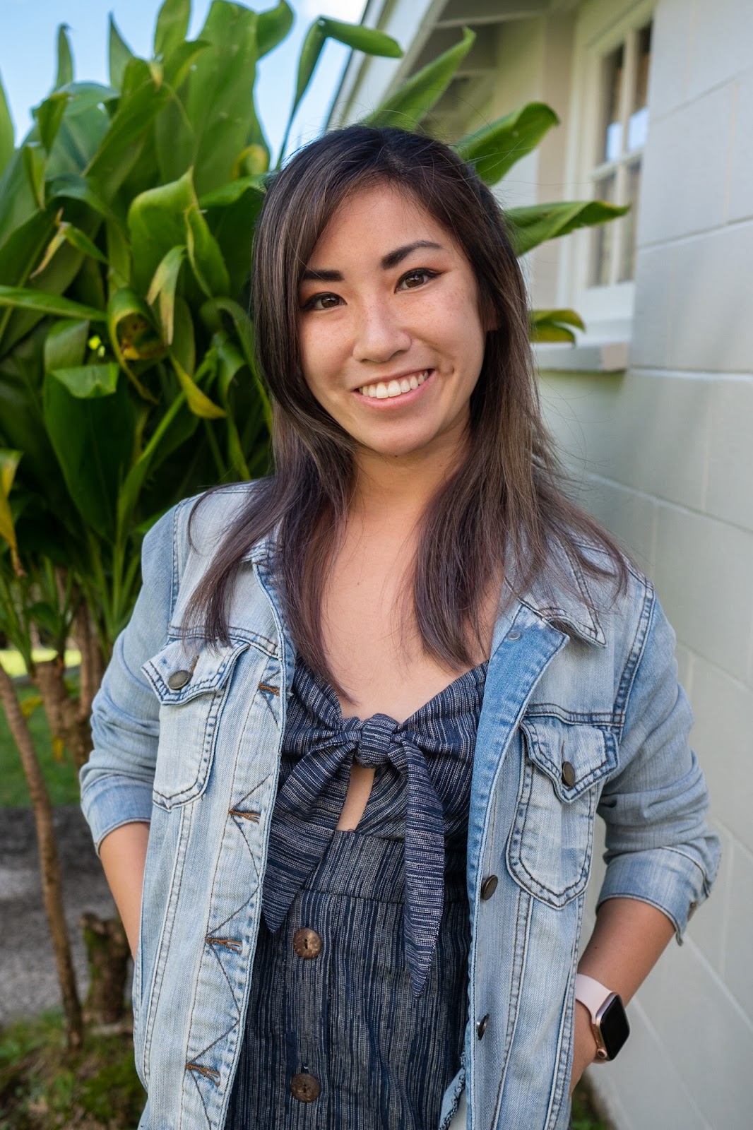 Katie Fujihara, smiling in a light denim jacket and navy top.