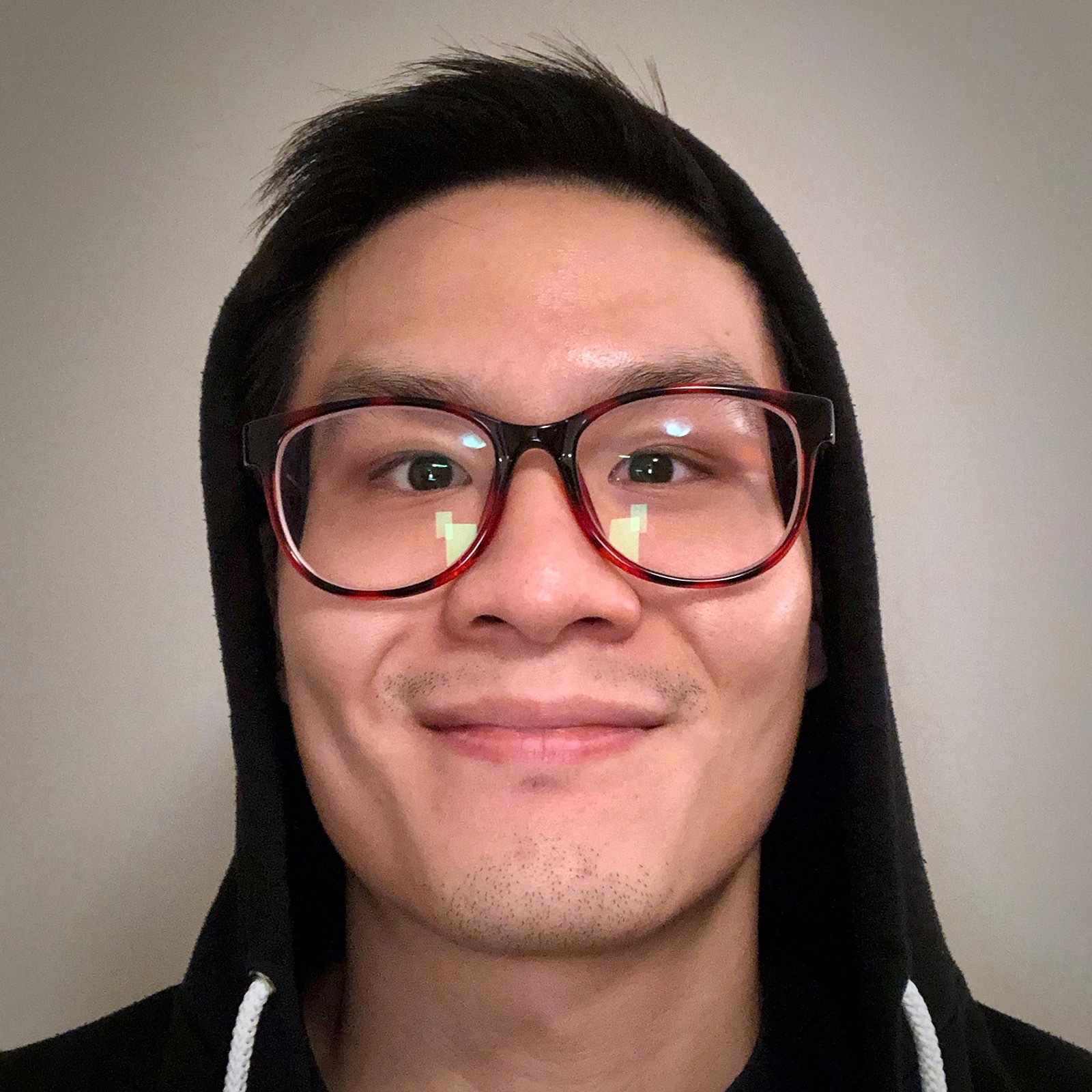 Jon Quach, close up photo, wearing a black hoodie, hood up. ,