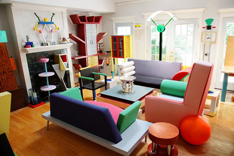 An image of a living room decorated in the Memphis interior design style. The living room featured bright colors and geometric shapes.