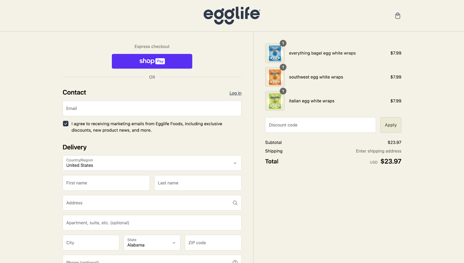 Egglife Foods’ checkout page design has a beige background with the company’s logo at the top. It shows a purple “Shop Pay” button above the input fields on the left side of the screen with the order summary on the right.