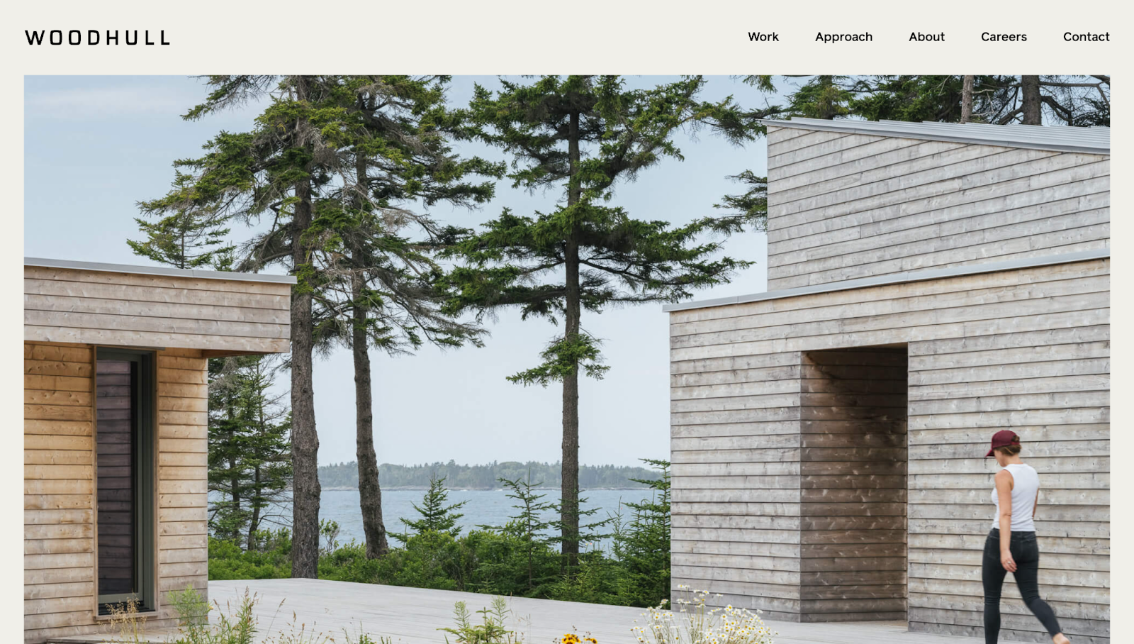 The Woodhull website shows a fullscreen hero image of a building project with the menu at the top.