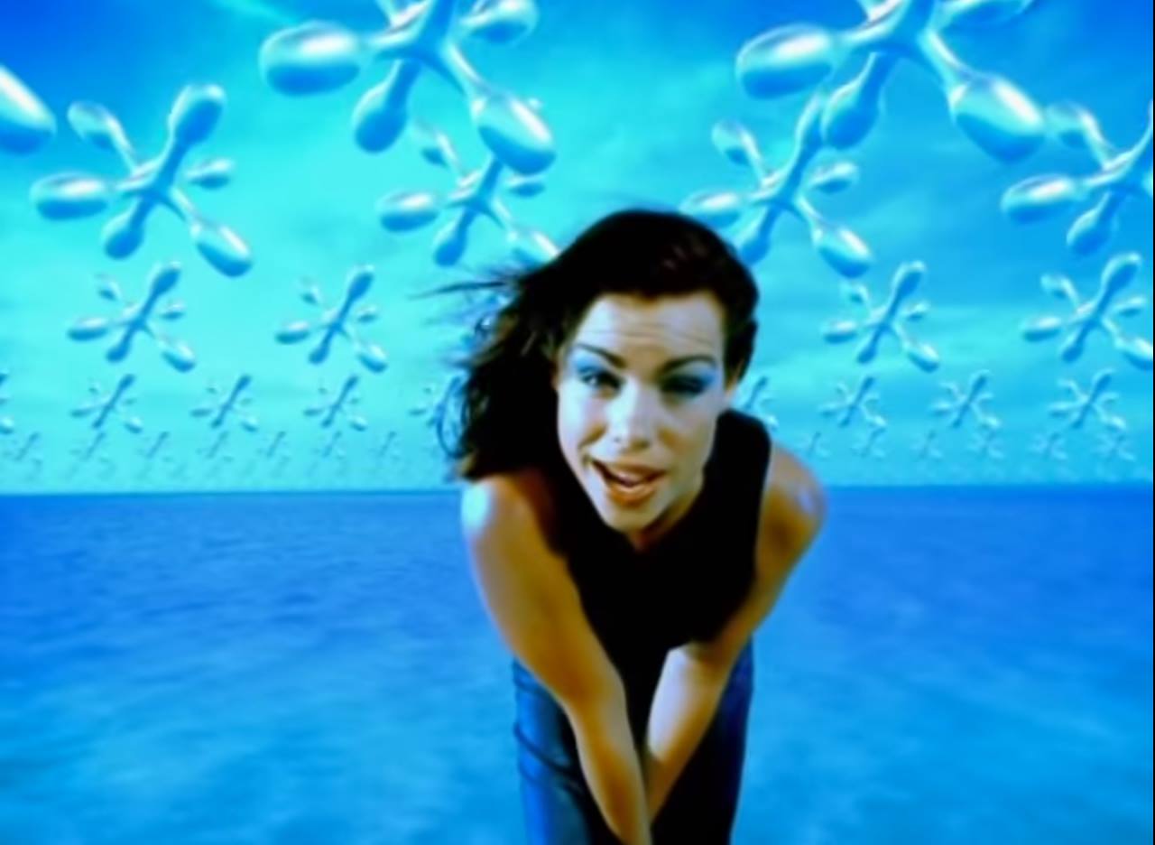 A vintage image of a woman with 90s style with a sky blue background with geometric floating flower shapes