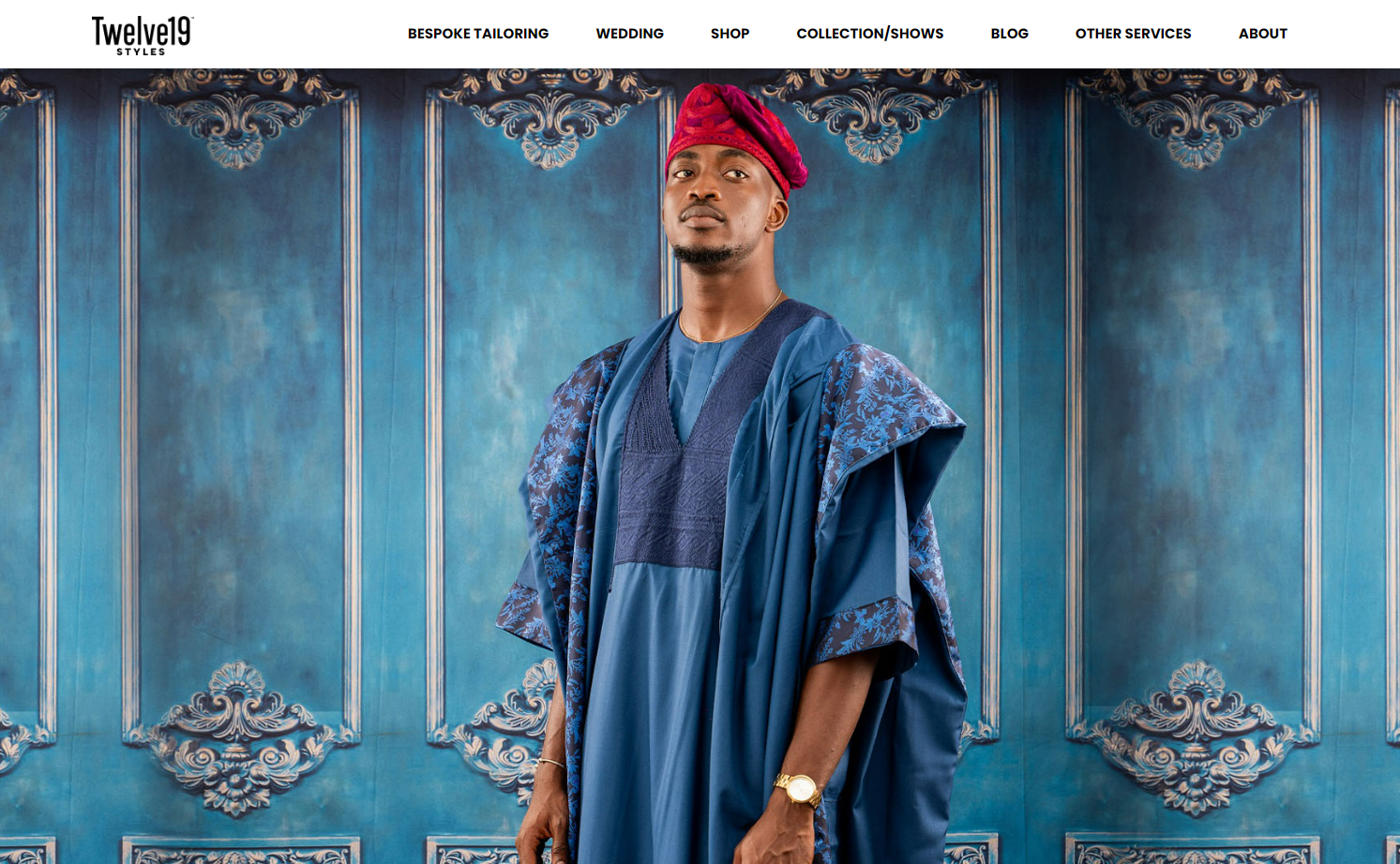 Twelve19styles’ site design with a full-page image of a Nigerian man wearing a dark-blue agbada (traditional dress), red fila (hat), and gold watch standing against a background of ornately carved blue wood.