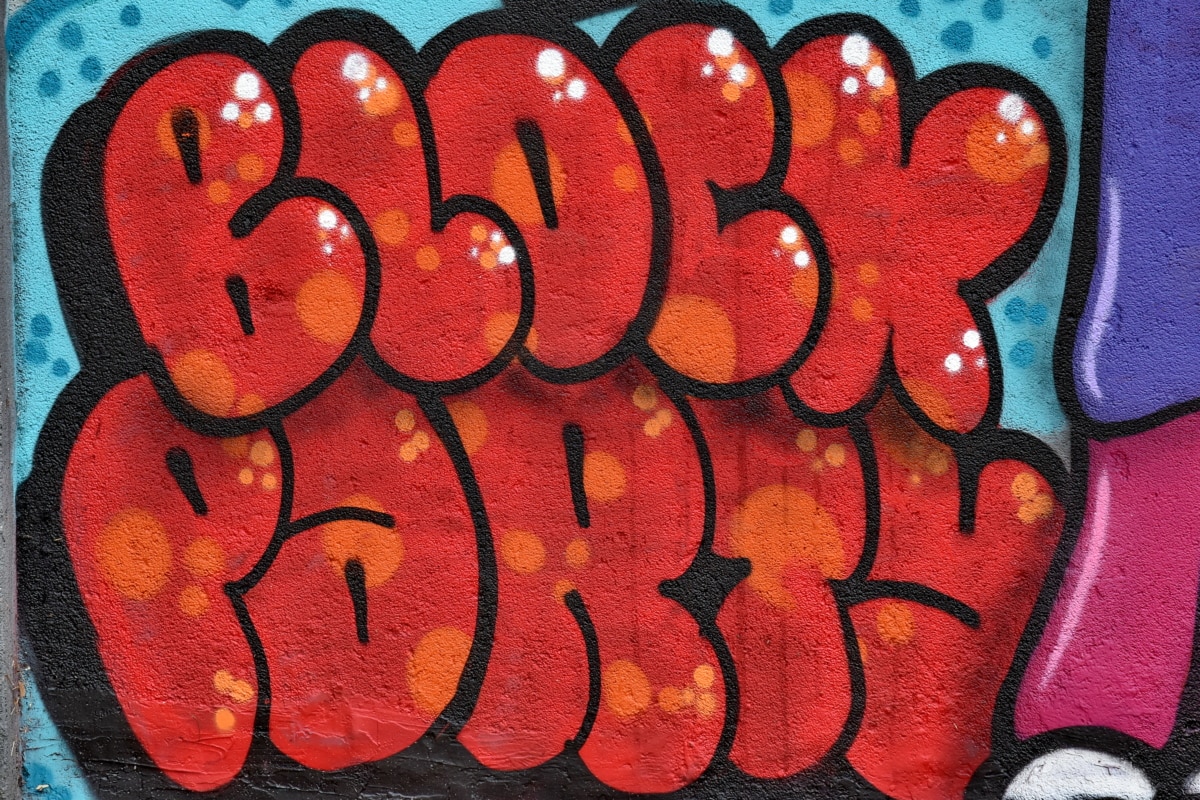 A photo of the words “block party” spray painted on a wall in bubble letters.