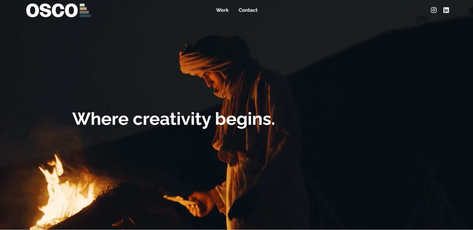 A screenshot of OSCO Studios’ website featuring an image of a man lighting a fire.