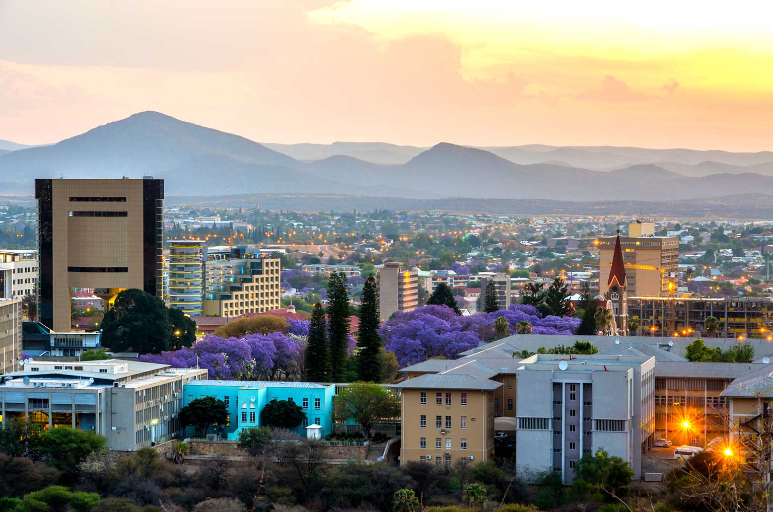 Namibia's capital city in the evening light. Rolling hills in the background. Showcasing an established and stable country and economy.