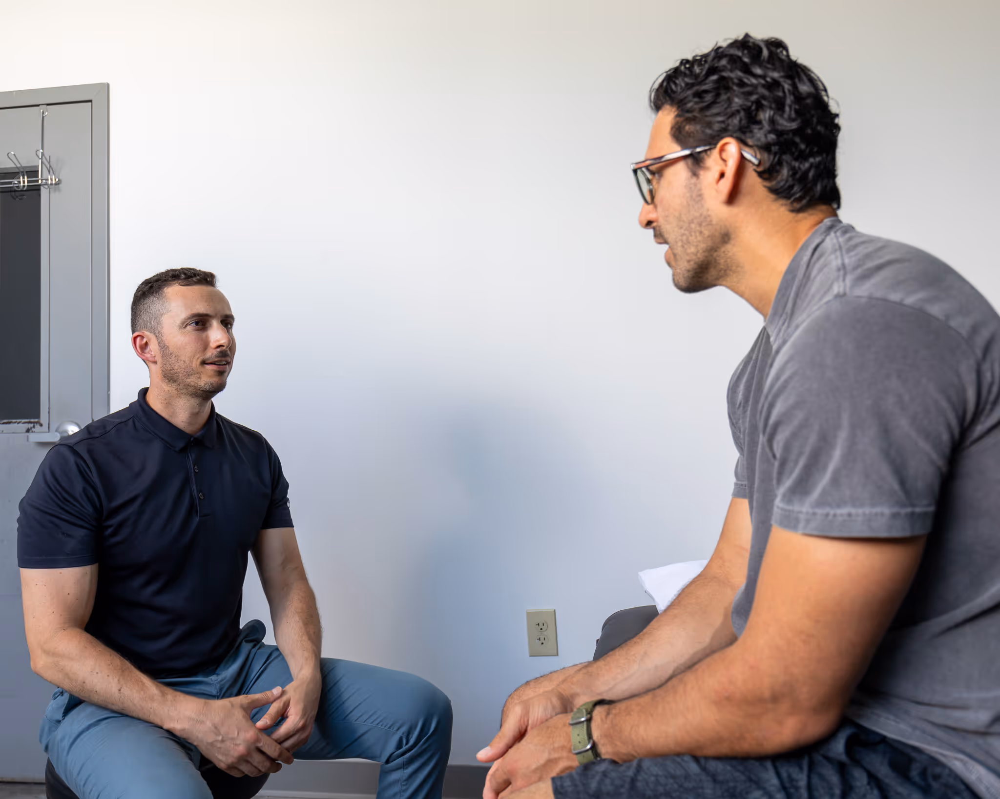 Eric speaking with a patient