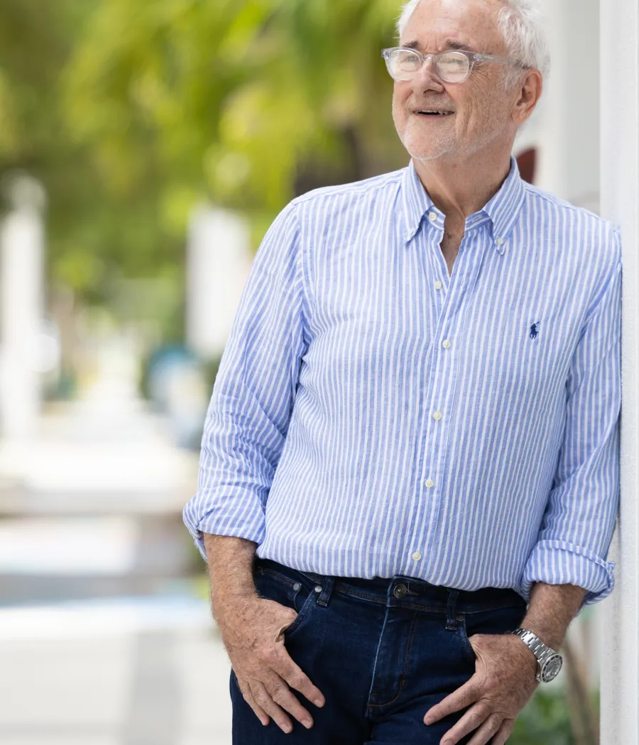 Jeff Anglin standing outdoors, smiling in a light blue shirt