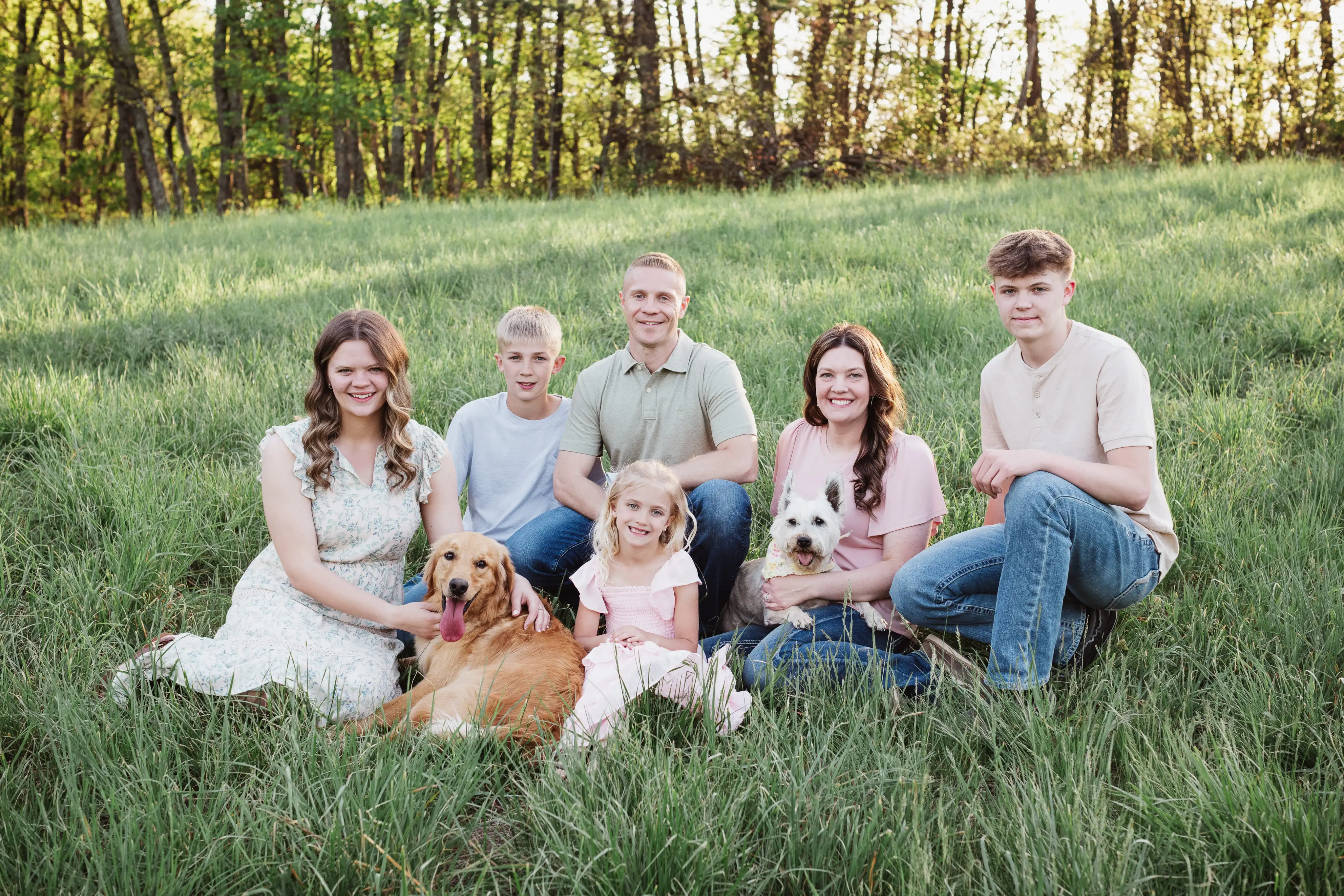 Jeremy, Starla, and their family with their dogs in a family photo