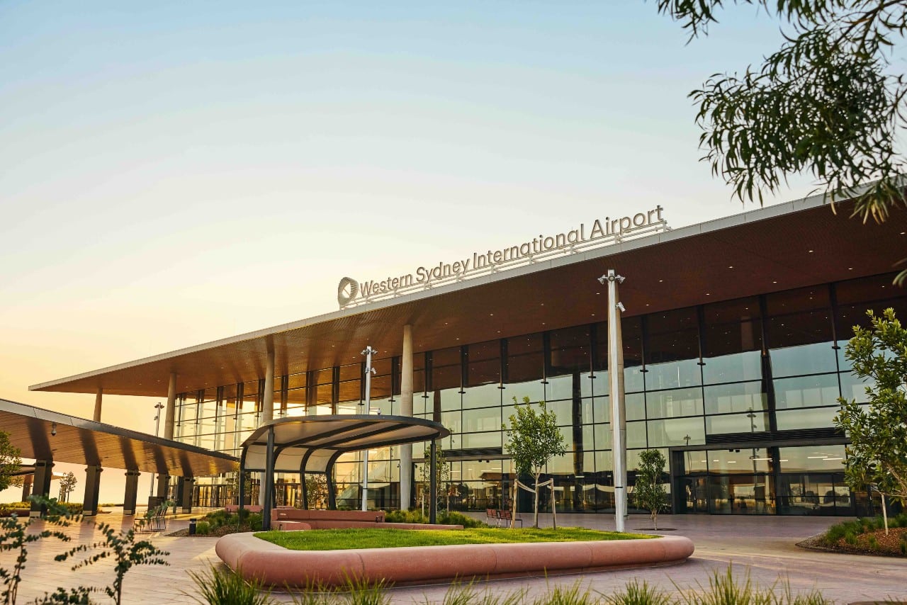 Western Sydney Airport, 17km from Gurner Grove Estate, Austral, NSW, featuring a modern terminal with glass facade, set to open in 2026, boosting connectivity.