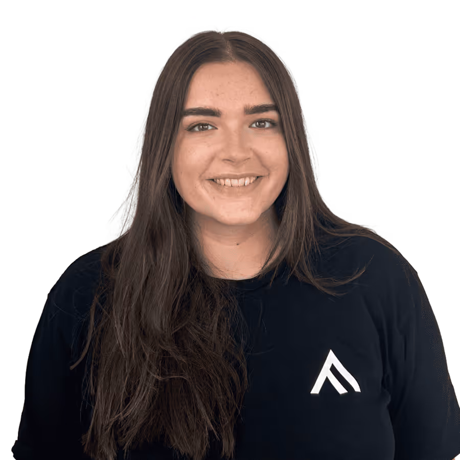 Smiling woman with long dark hair wearing a black shirt with a white logo.