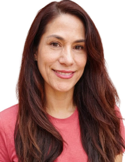 Smiling woman with long brown hair wearing a pink shirt, facing forward with a friendly expression.