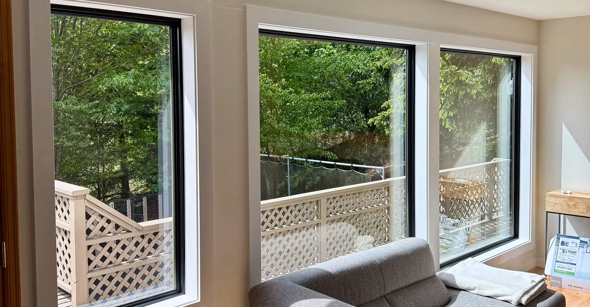 New black-framed replacement windows installed in a Seattle-area living room