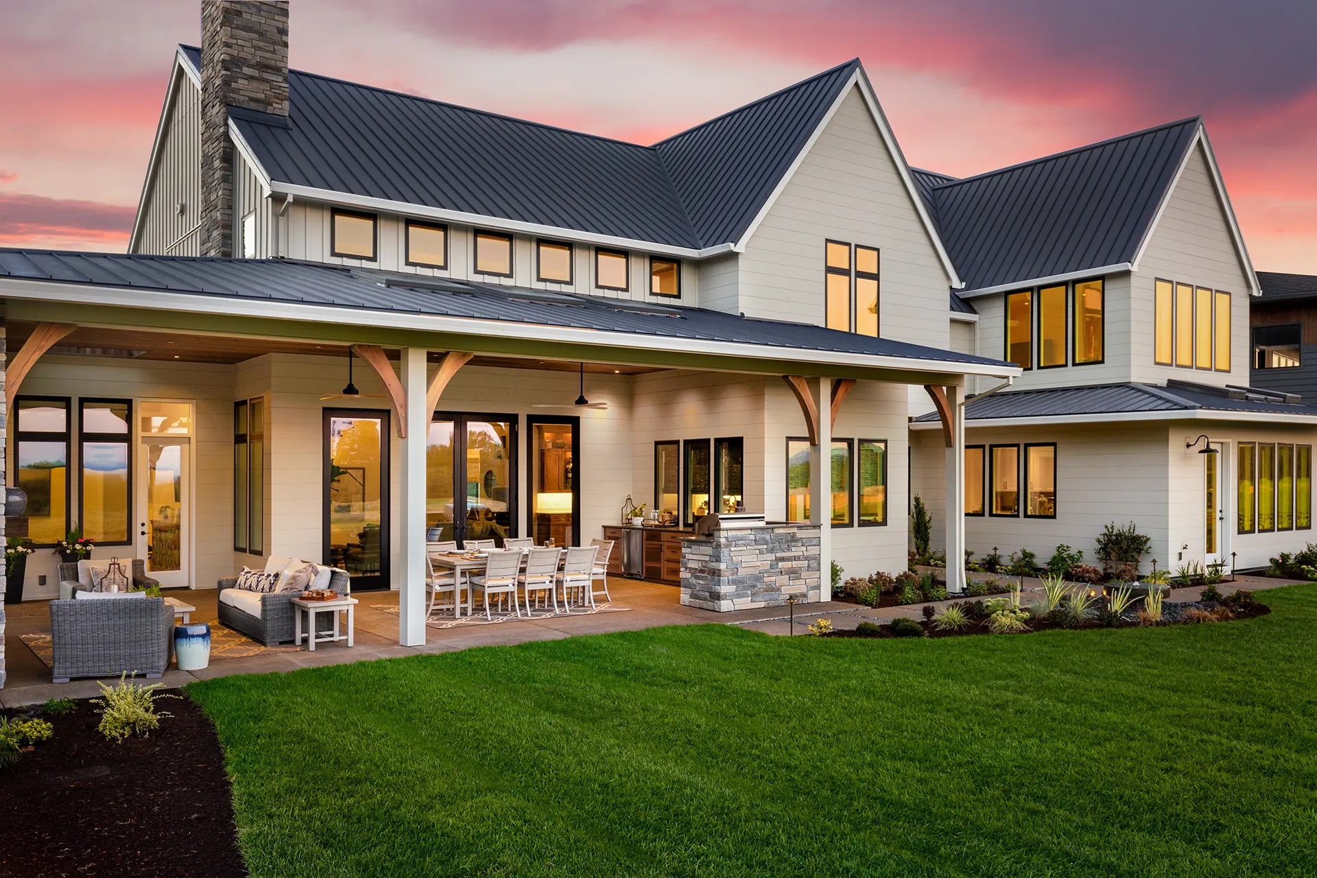 Modern home exterior with glass patio doors opening to a covered patio