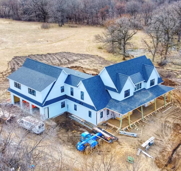 Aerial view of a residential home with a newly installed roof