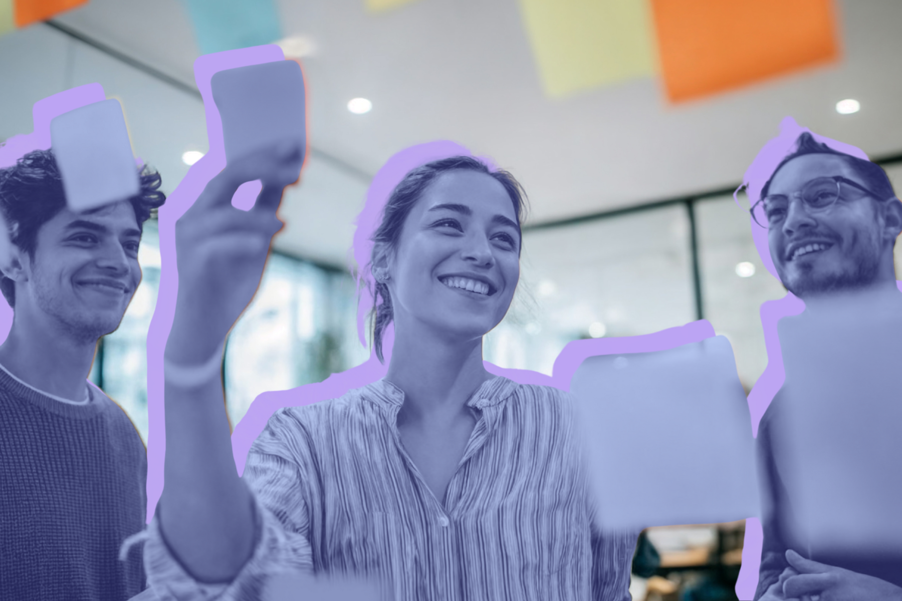Three people smiling and holding sticky notes in a modern office setting, outlined in purple, with colorful notes hanging in the background.