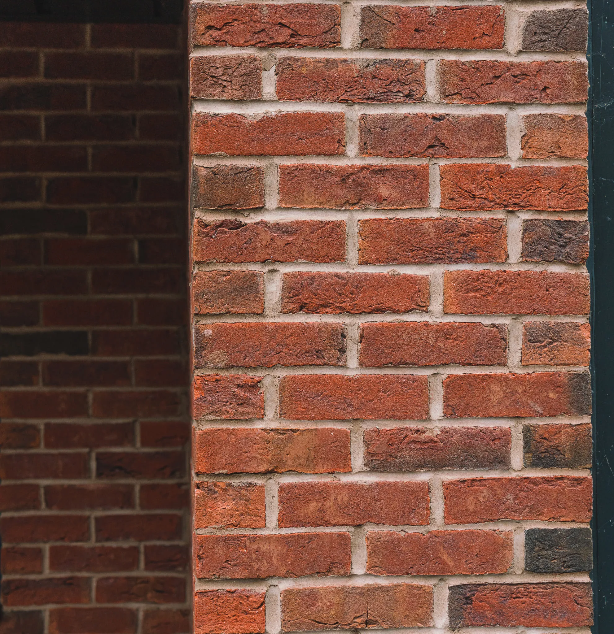 Architectural brickwork detail featuring red multi-toned bricks and clean mortar lines