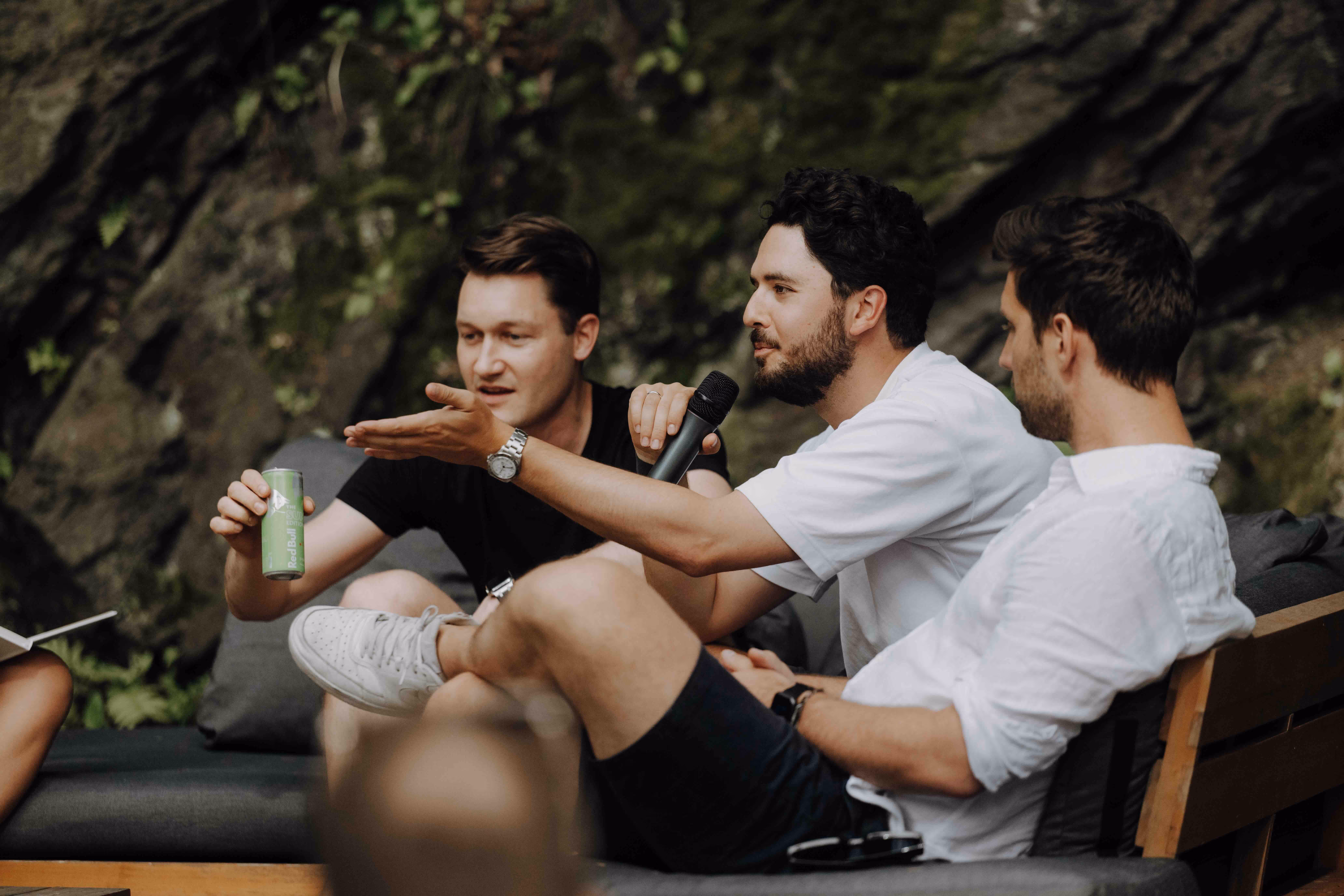 three man sitting outside