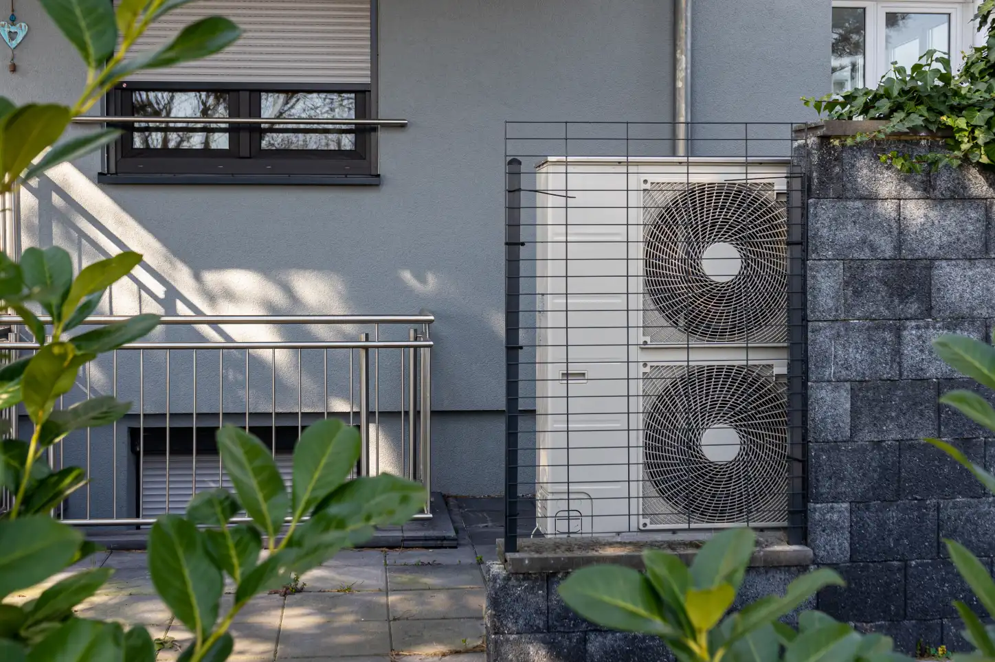 A couple of air fans sitting on the side of a building.