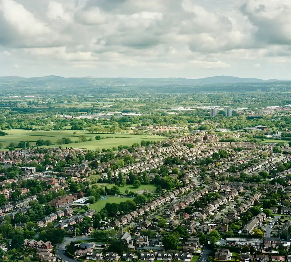 An aerial view of a city with lots of trees.
