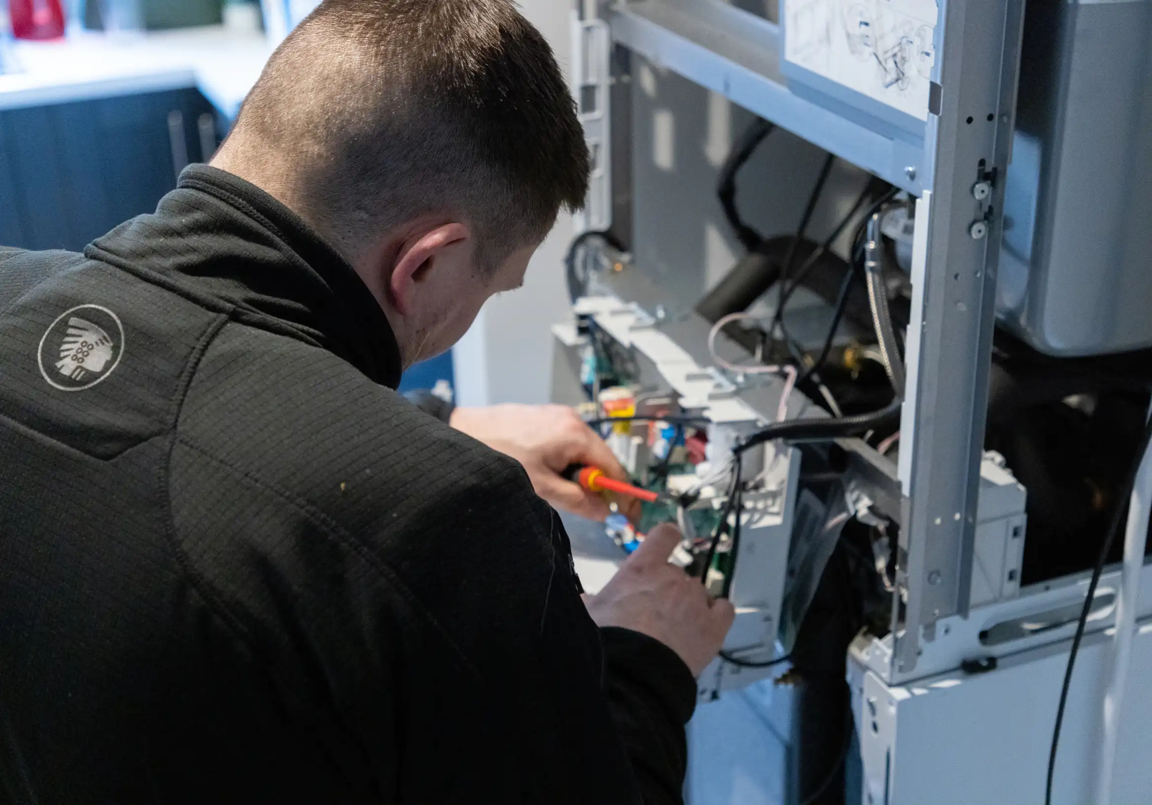 A man working on an electrical panel.