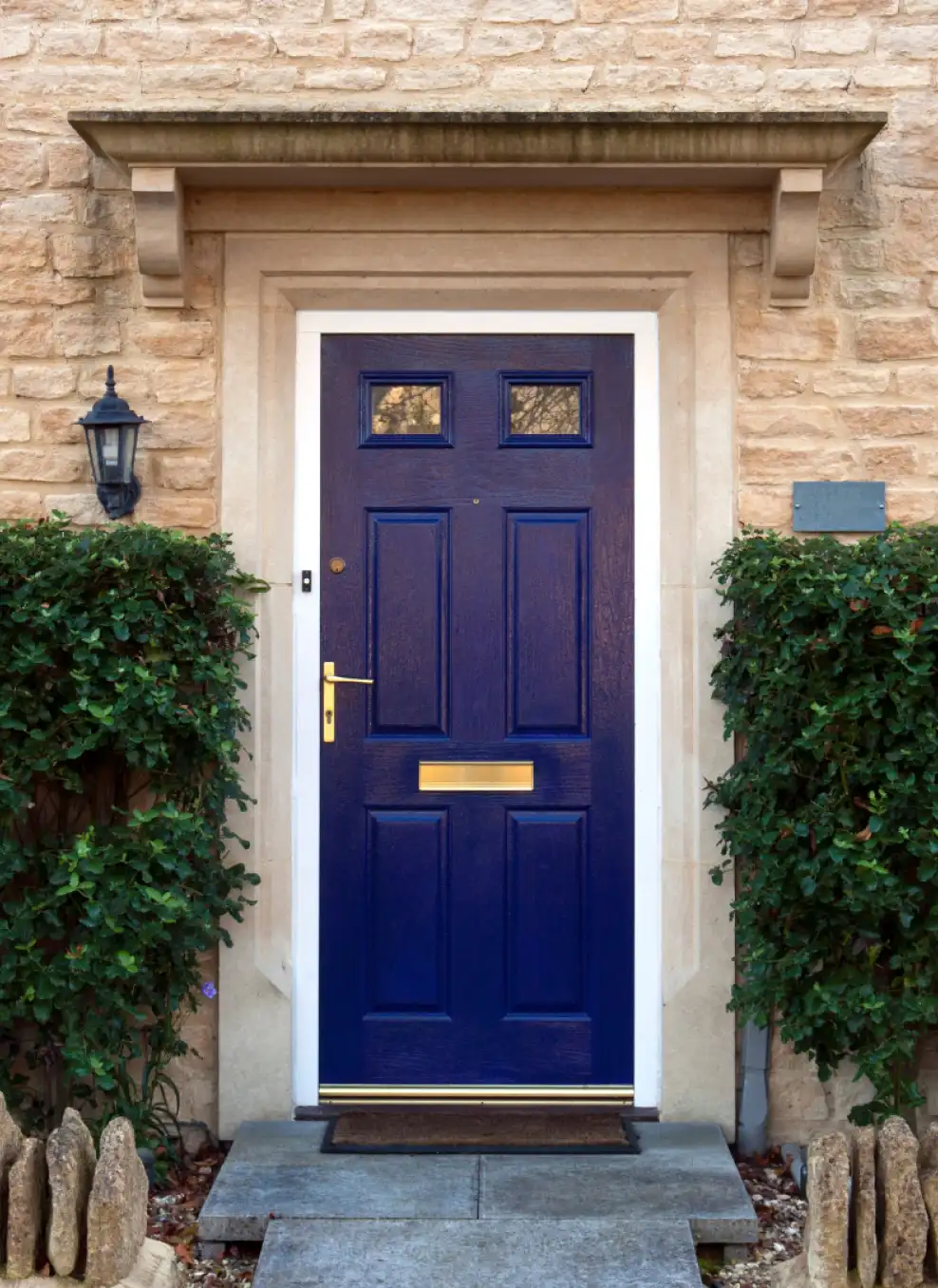 A blue front door with a light on.
