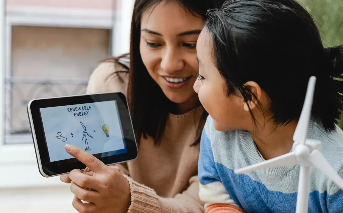 A woman and a child playing with a tablet.