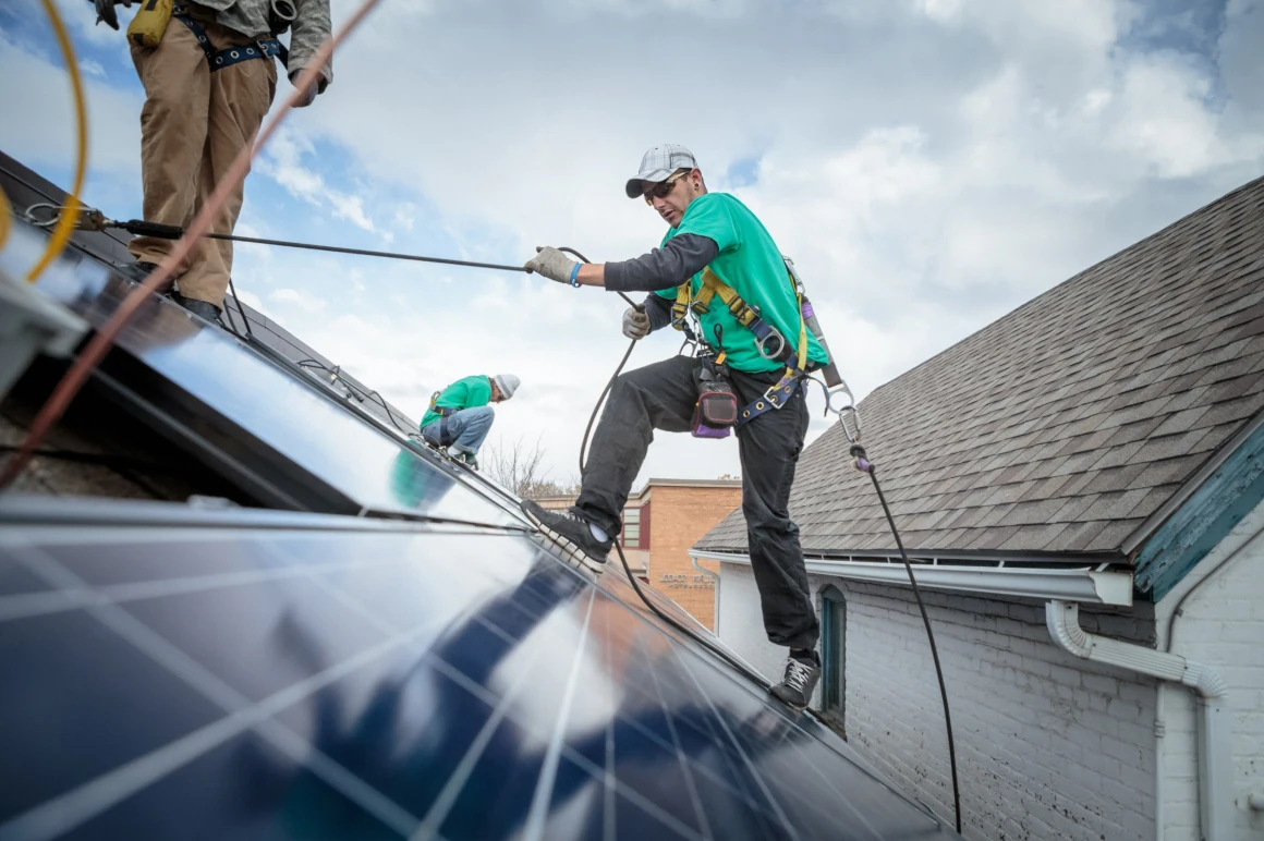 A couple of men working on a roof.
