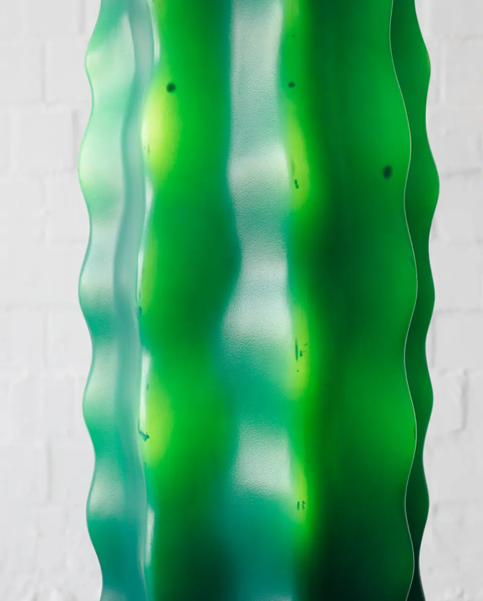 Detail shot of illuminated green cactus lamp showing inner light glow and surface texture