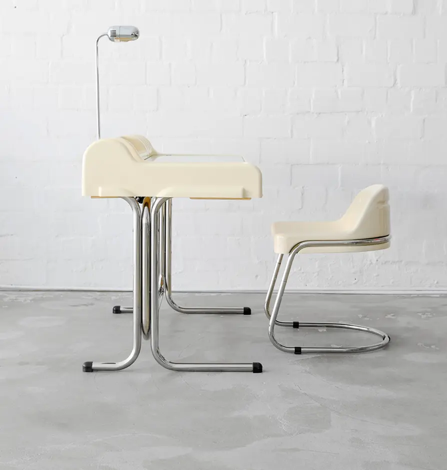 Cream-colored vintage desk with matching chair and chrome legs.