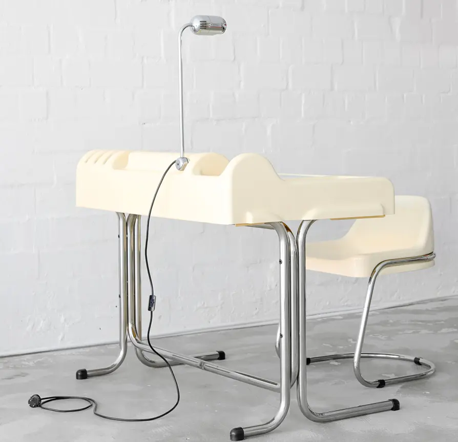 Vintage children's desk with integrated lamp and plastic chair on chrome legs