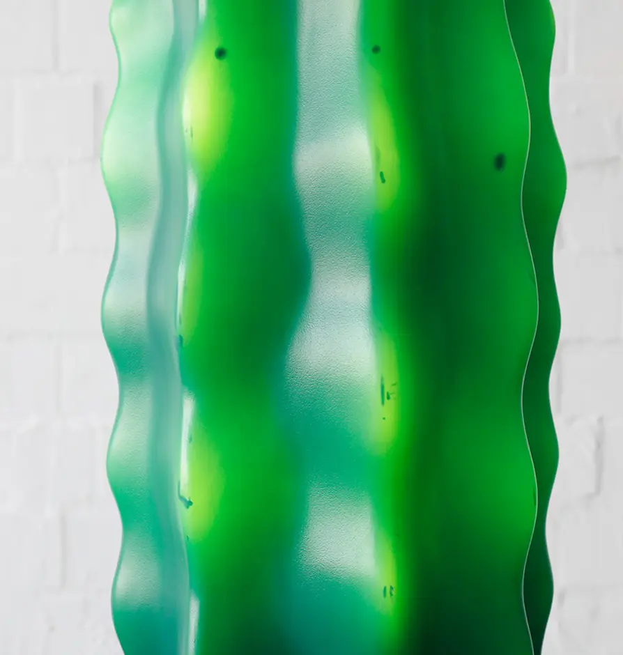 Textured surface close-up of a green cactus-shaped floor lamp
