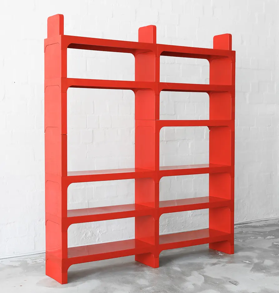 Tall red modular bookshelf with multiple open shelves.