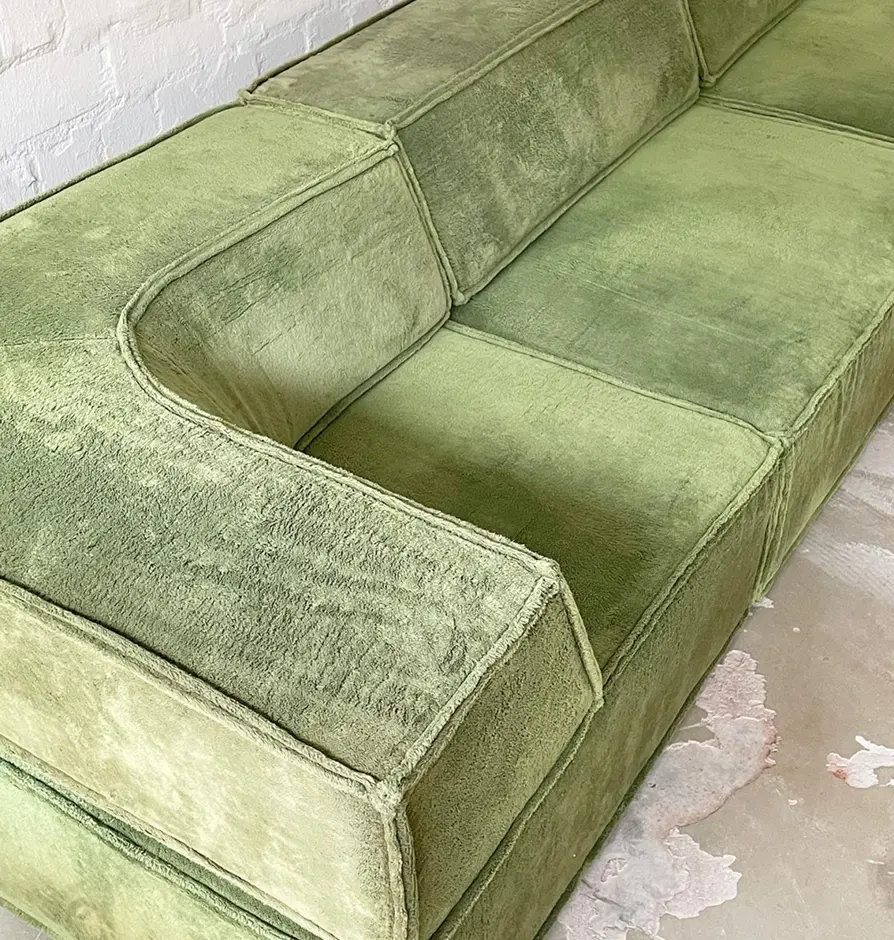 Close-up of retro green velvet modular sofa