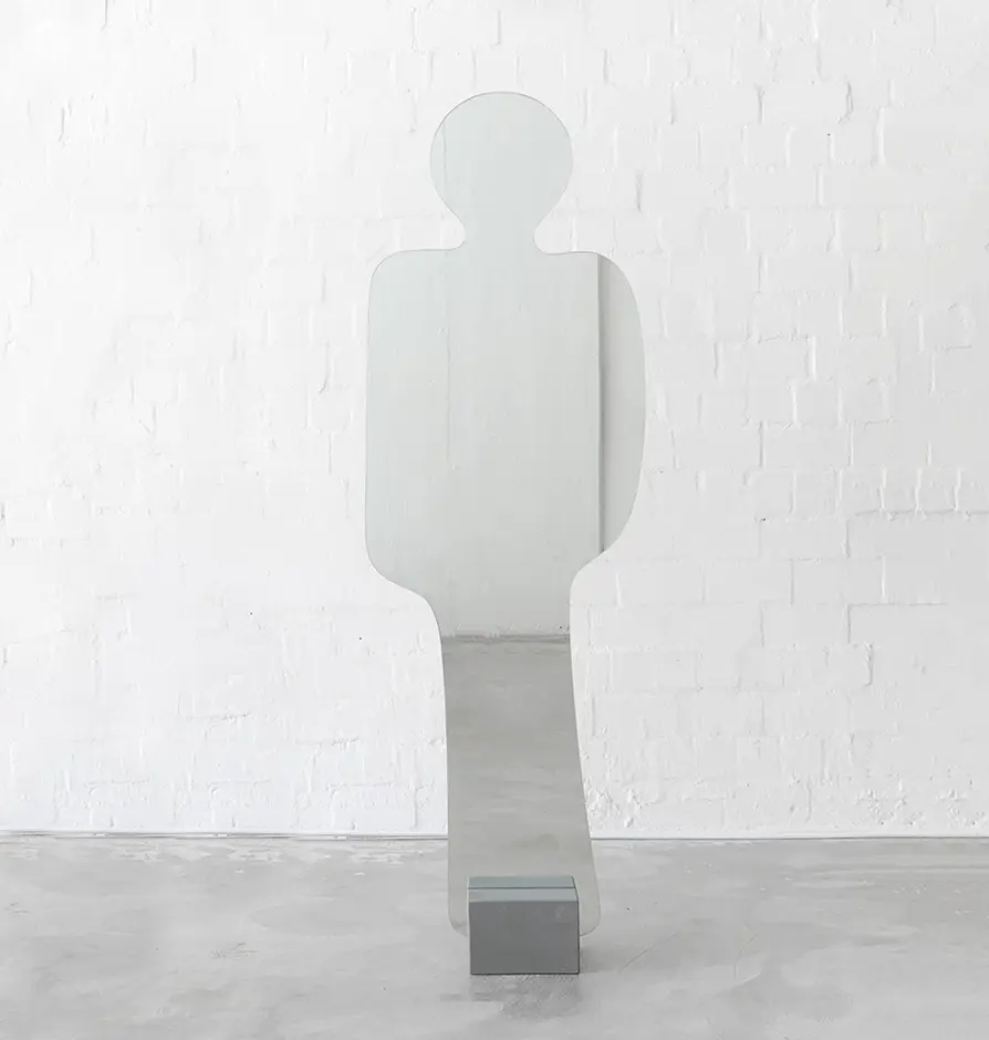 Standing mirror shaped like a human figure with abstract silhouette
