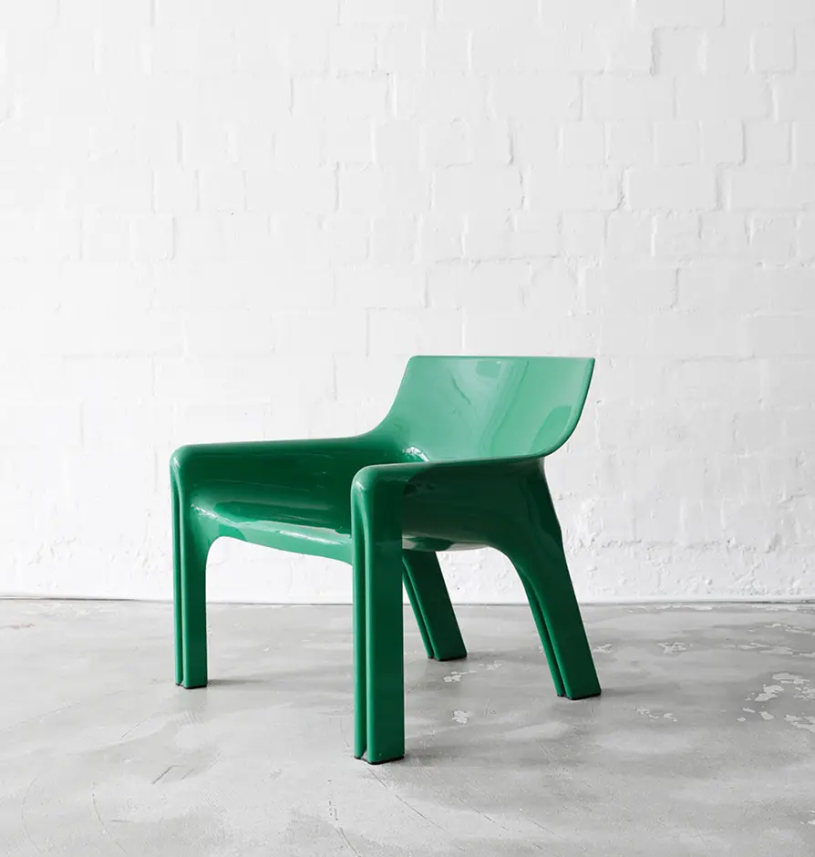 Vintage green molded plastic armchair with wide seat and minimalist design