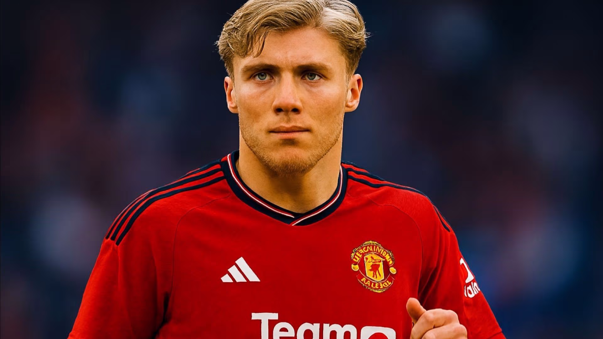 Slightly zoomed‑out 16:9 photograph of Rasmus Højlund, Danish striker for Manchester United, wearing the red home jersey with black collar trim, white Adidas stripes on the shoulders, Manchester United crest on the left chest, and “TeamViewer” sponsor acro