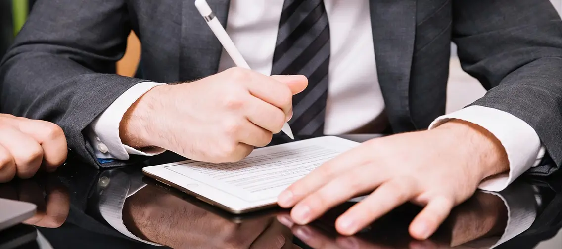Person reviewing and signing a commercial contract
