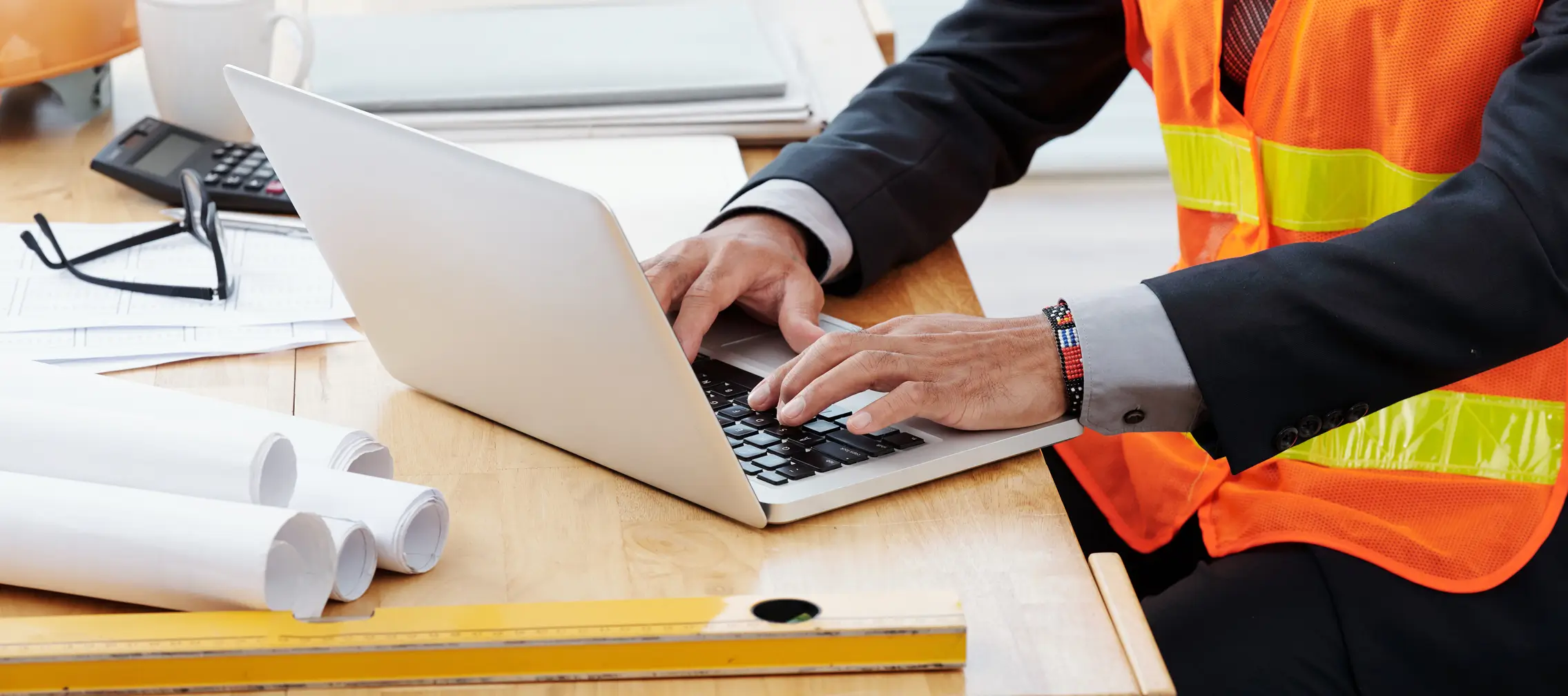 Contractor completing project documentation on a laptop