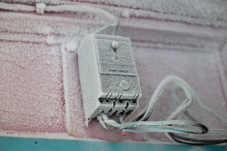 A frozen evaporator coil covered in thick white ice due to a lack of airflow from a failed blower motor A frozen evaporator coil covered in thick white ice due to a lack of airflow from a failed blower motor