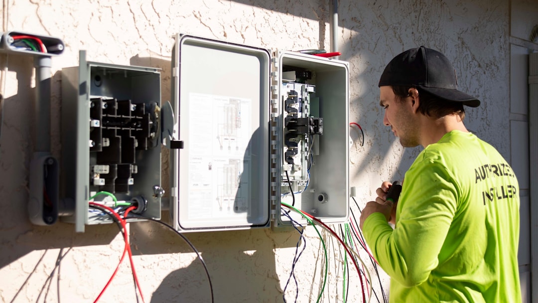 Technician assessing a home electrical panel for mini split capacity - what to expect during a ductless mini split Technician assessing a home electrical panel for mini split capacity - what to expect during a ductless mini split