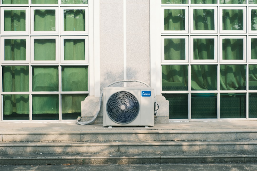Professional technician inspecting an outdoor HVAC unit in a Pittsburgh backyard - heat pump maintenance vs ac maintenance Professional technician inspecting an outdoor HVAC unit in a Pittsburgh backyard - heat pump maintenance vs ac maintenance