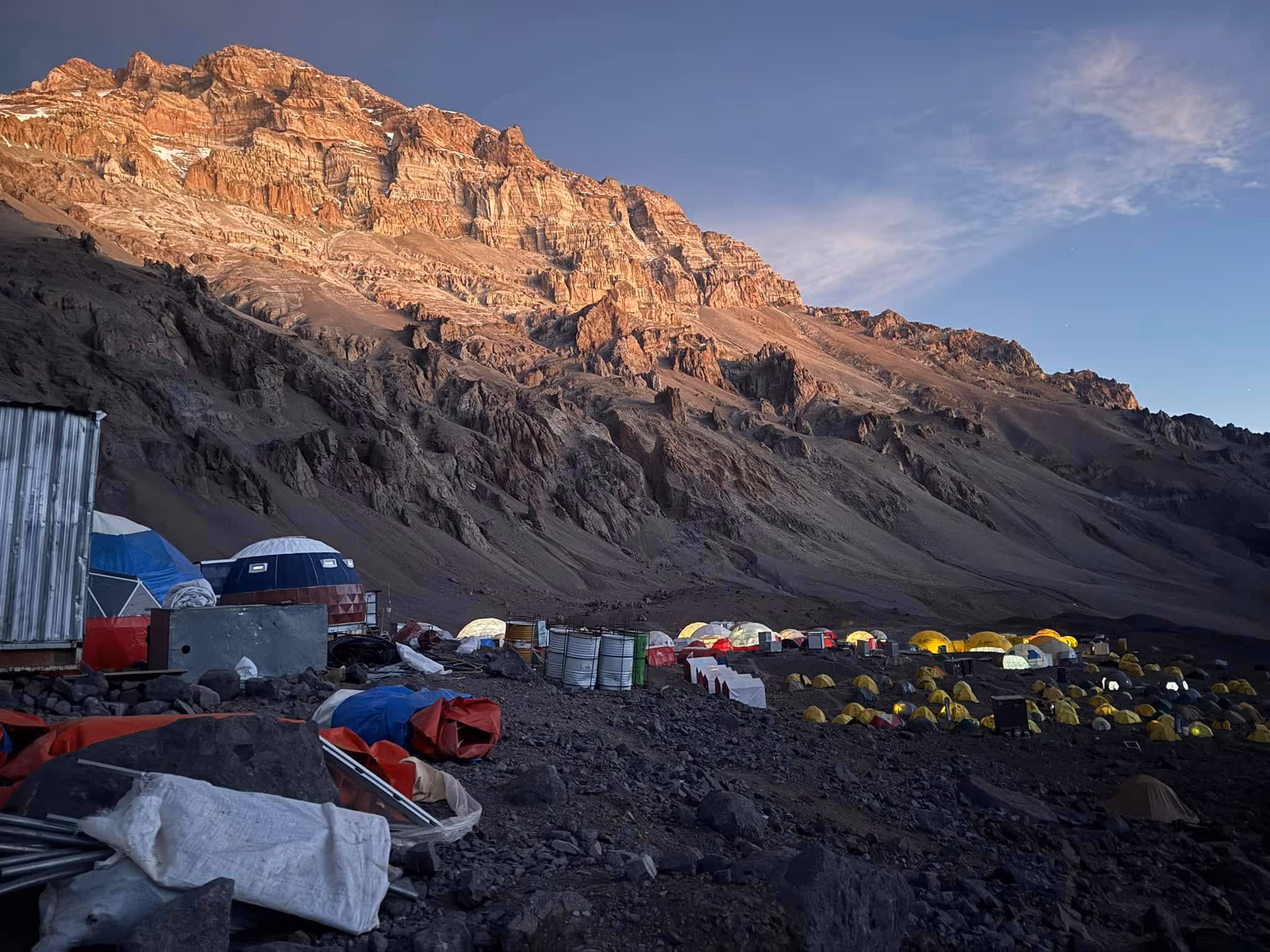 A mountain with a tent camp on top.