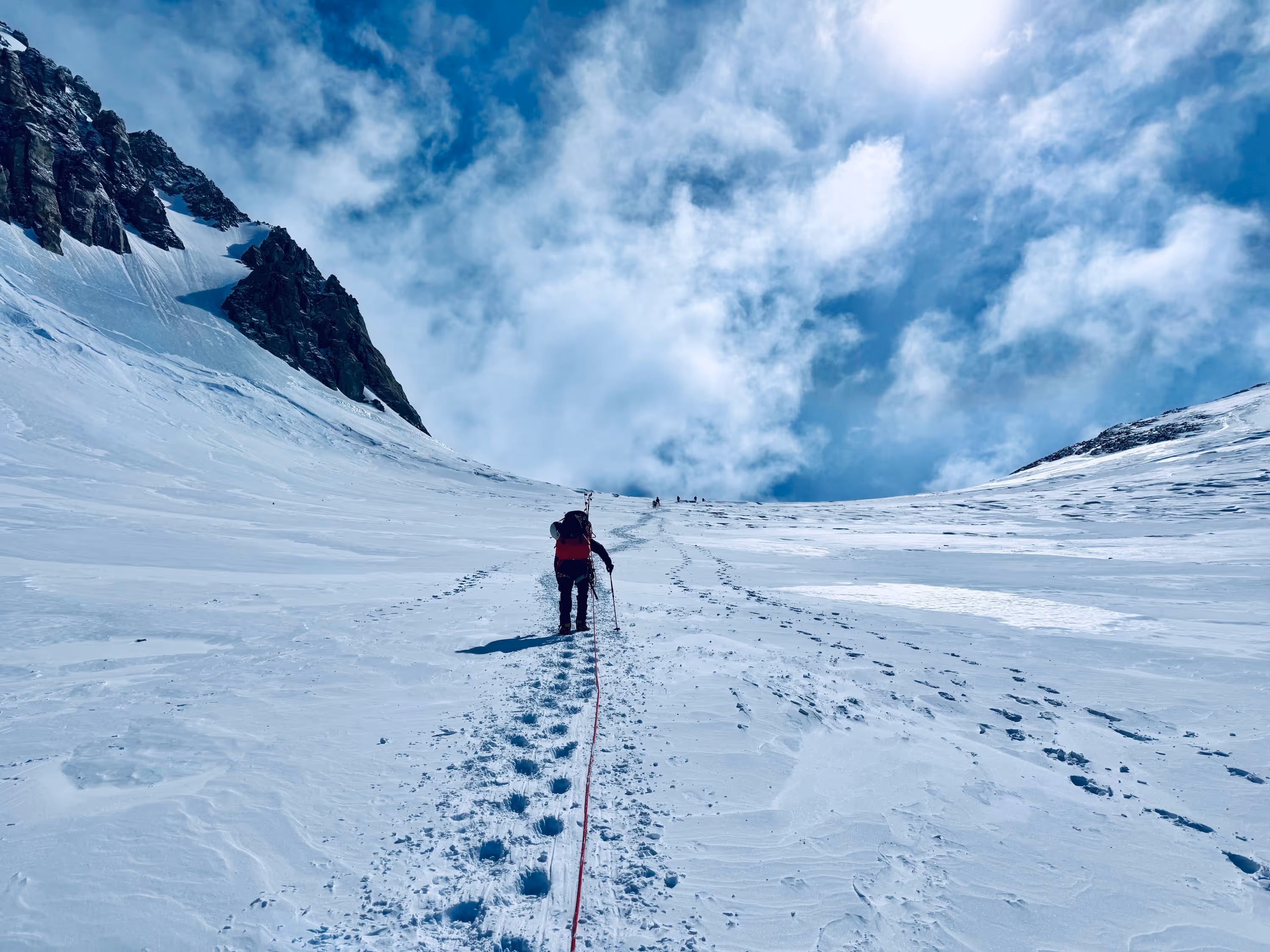A person is walking up a snowy mountain.