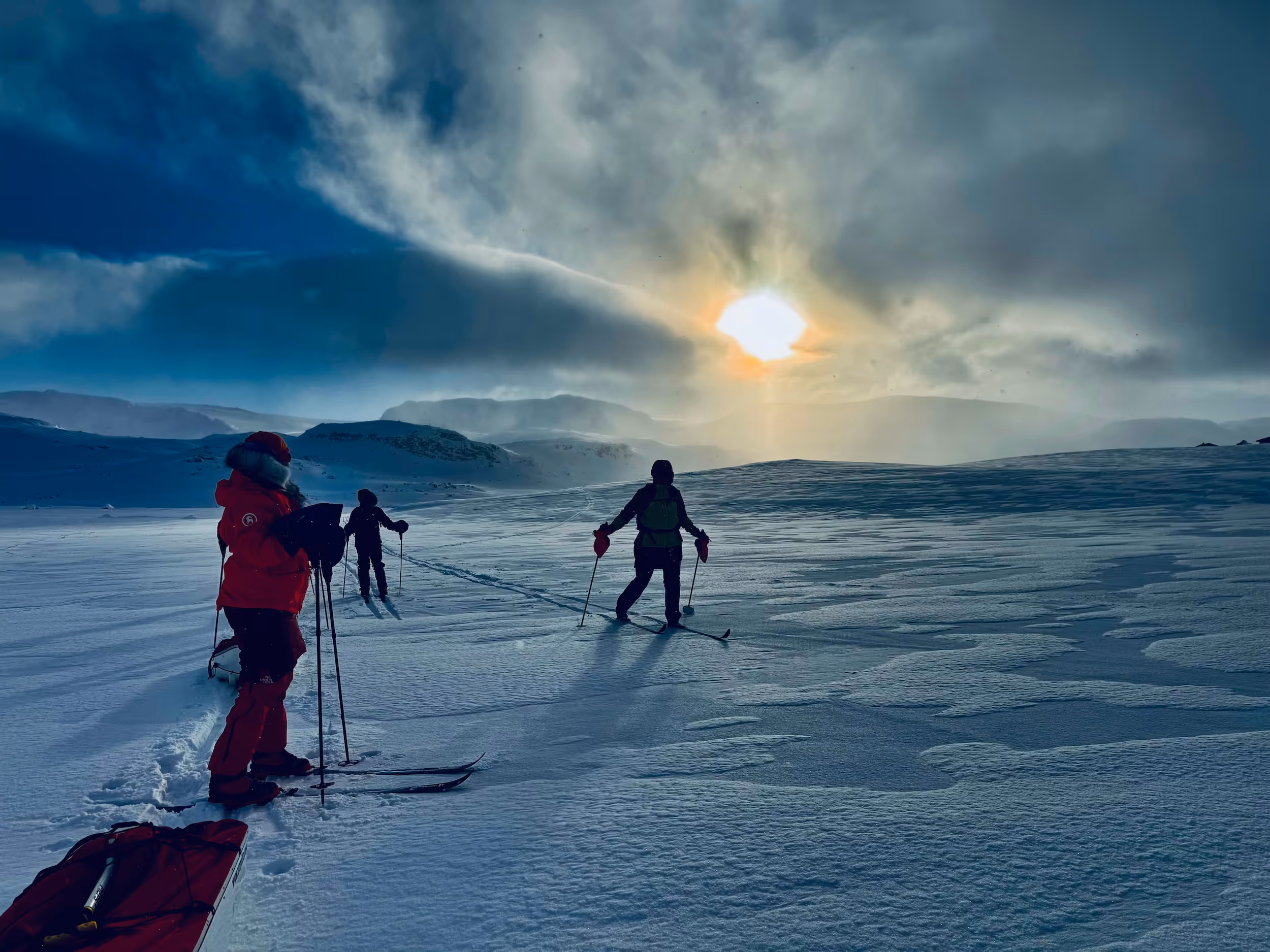 Three people skiing in the snow.
